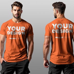 以下が含まれることがあります： 明るいオレンジ色の半袖Tシャツで、白い文字で「YOUR DESIGN」と書いてあります。メインのテキストの下には、白い文字で「MEXESS STUDIO」と書いてあります。