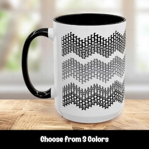 May include: A white ceramic mug with a black handle and interior. The exterior features a repeating pattern of three horizontal wavy lines composed of small, stacked black and gray geometric shapes arranged in a chevron-like formation.