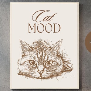 Puede incluir: Un cuadro enmarcado con un boceto marrón de la cara de un gato y las palabras "Cat MOOD" arriba. El cuadro está sobre un fondo crema y se muestra en una pared gris. El texto "byNieSpain DigCreations" está en la parte inferior.