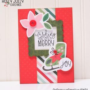 May include: A red and green Christmas card with a white frame that says "Wishing you lots of Merry". There is a green ice skate with a red flower on it and a white circle that says "joy".