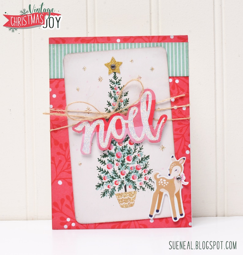 May include: A pink and white Christmas card with a green and gold Christmas tree, a deer, and the word "no&euml;l" in pink glitter letters.