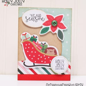 May include: A Christmas card with a red and white sleigh carrying presents and a hedgehog. The card has a green and white striped background with a red and white striped border. The card also has a red poinsettia flower with a green button in the center. The card says "'tis the season" and "Holly Jolly Christmas".