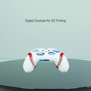 May include: White Xbox controller with a baseball-themed design. The controller has red stitching around the edges and a white background with red stitching.