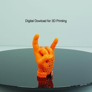May include: Orange 3D printed hand model making the rock and roll hand gesture. The hand is printed with a lattice pattern.