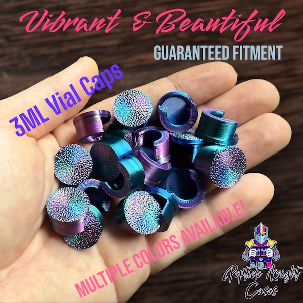 May include: A handful of iridescent 3ML vial caps in shades of purple, blue, and teal. The caps have a textured surface and are shown against a blurred background. Text includes "Vibrant & Beautiful", "Guaranteed Fitment", and "Multiple Colors Available!"