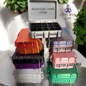 May include: A stack of colorful cases with the text "BRUSHED SILVER + CARBON INTERIOR". Colors include golden red, black and purple, marble, deep rainbow, cotton candy pink, and green. The text "More colors coming!" is also visible.
