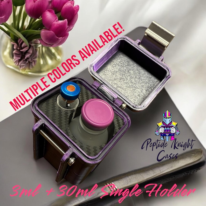 May include: A purple and black case with a carbon fibre interior, designed to hold two vials. The case is open, revealing the interior and a vial with a purple cap. The case is labelled "Peptide Knight Cases" and "Multiple Colours Available!"