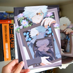 May include: A rectangular art print featuring an anime-style character with white hair and a monocle, holding a series of nested picture frames. The illustration includes light purple and blue flowers, creating a recursive visual effect of the character.