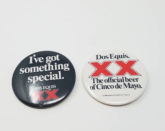 Dos equis beer XX the official beer of Cinco De Mayo advertising tin pinback button 1988 set of 2