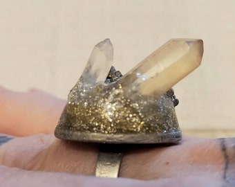 Ring with Golden Sparkling pyrite and two Colred Quartz Points on siver adjustable ring.