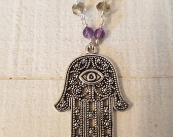 The Hamsa charm necklace for luck and protection with amethyst and faceted smokey quartz stones.