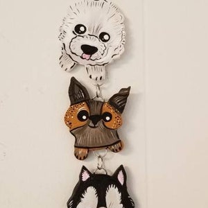 The Six Hand Sculpted Mixed Puppy Hanging Wall Art Sculpture with little hand sculpted Dog bone drop.
