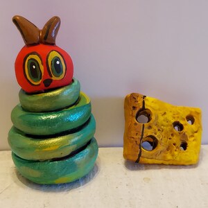 The Hungry Caterpillar Peg Doll with a Cheese Slice