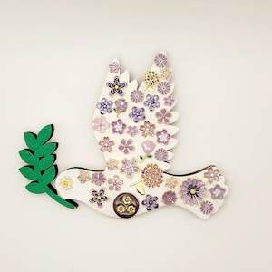 Dove of Peace Wall Décor, Peace Dove, Pentecost Dove, left-facing, made of painted wood, and adorned with pretty purple floral charms.