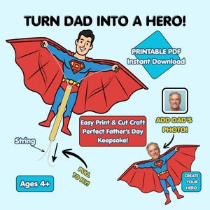 May include: A printable craft kit featuring a cartoon superhero with a red cape and blue suit. Text includes TURN DAD INTO A HERO!, PRINTABLE PDF Instant Download, Easy Print & Cut Craft, ADD DAD'S PHOTO!, PULL TO FLY!, and Ages 4+. Includes a string component.