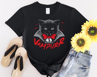 May include: Black t-shirt with a graphic of a black cat wearing a vampire costume and the text "The Return of Vampurr".