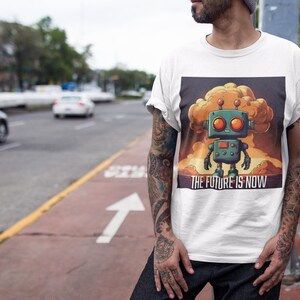 May include: White t-shirt with a graphic of a cartoon robot standing in front of a large explosion. The text "THE FUTURE IS NOW" is printed below the robot.