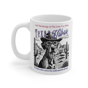 May include: White ceramic mug with a black and white illustration of a dog wearing a cowboy hat and sunglasses. The text "Feel The Energy of The Lone Star State Texas Vibes" is printed on the mug. The text "For those who chase the wild and live freely." is printed at the bottom of the mug.