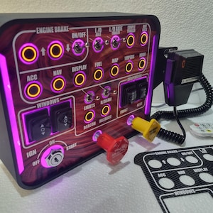 May include: A custom control panel with a wood grain design and purple LED lighting. It features various switches, buttons, and indicator lights labeled for different vehicle functions. Includes a microphone and a remote control.