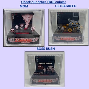 Op de afbeelding: Drie transparante acryl display-kubussen met personages uit het videospel The Binding of Isaac: Repentance. De kubussen tonen de personages Mom, Ultra Greed en Boss Rush. Elke kubus heeft een zwarte basis met het logo en de titel van het spel.