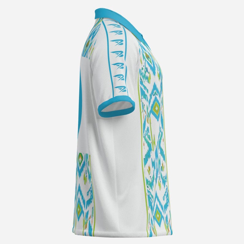 May include: White short-sleeved shirt with a turquoise collar and sleeve trim. The shirt features a repeating geometric pattern in turquoise and green. The design is reminiscent of tribal or ethnic textiles.