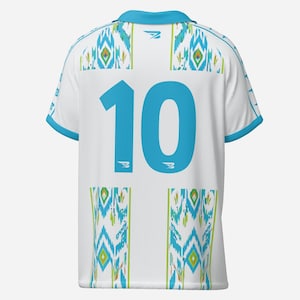 May include: White athletic jersey with a turquoise collar and trim. The number 10 is prominently displayed on the back in turquoise. The jersey features a geometric pattern in turquoise, green, and yellow.