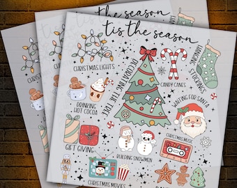 May include: Three DTF transfer sheets with Christmas-themed illustrations. The designs include a decorated tree, Santa, candy canes, and the text "The season tis the season". Other elements include Christmas lights, gift giving, and baking cookies.