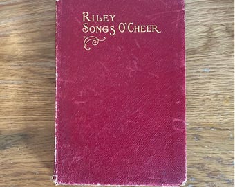 May include: A red hardcover book with the title "Riley Songs O'Cheer" in gold lettering.