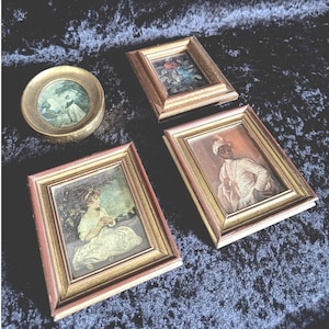 May include: A collection of antique framed miniature paintings. The frames are gold-toned with red accents. The paintings depict various scenes, including portraits and floral arrangements. One painting is round, while the others are rectangular.