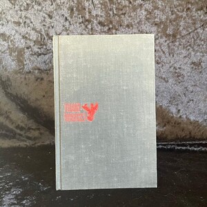 May include: A hardcover book with a gray cover and the title "Train Wreck!" in red lettering. The book has a simple, vintage design, with the title and a red graphic on the front cover.
