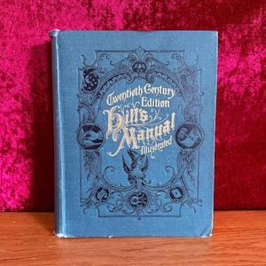 May include: A blue book with gold lettering on the cover. The title is "Twentieth Century Edition Hill's Manual Illustrated".