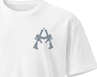 May include: White t-shirt with a gray graphic of two guns forming the letter A.