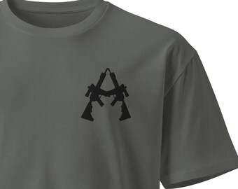May include: A dark gray t-shirt with a black graphic of two rifles forming the letter "A".