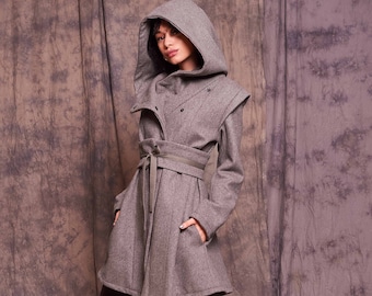 May include: A gray hooded coat with a tie belt and a long, flowing skirt. The coat is made of a soft, warm fabric and has a relaxed fit.