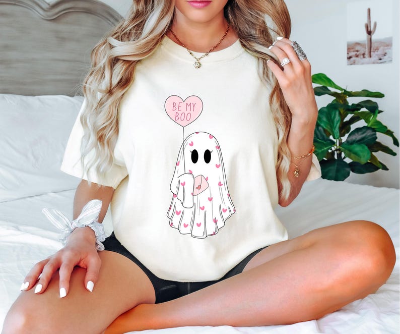 May include: White t-shirt with a ghost holding a pink heart balloon that says "Be My Boo".