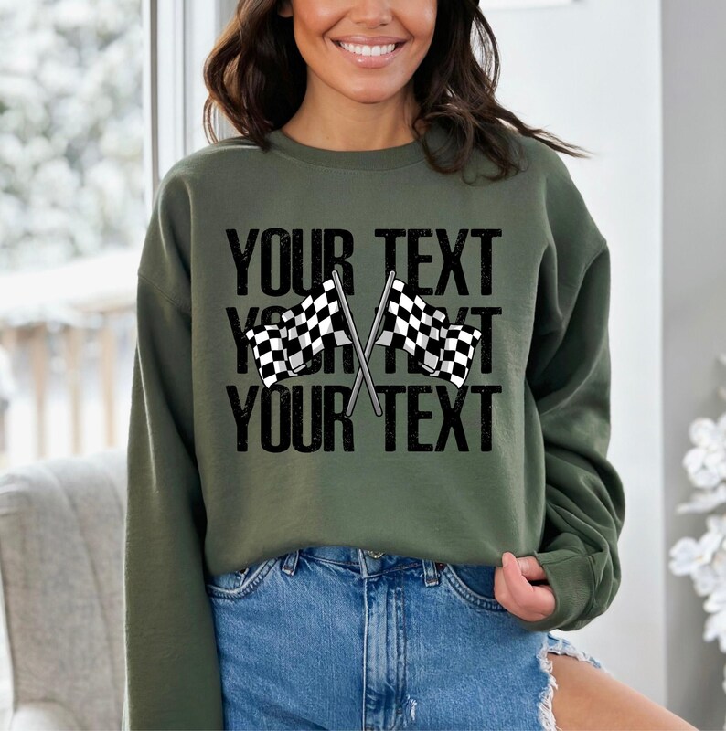 May include: Olive green sweatshirt with a black and white checkered flag graphic and the text "YOUR TEXT" repeated three times.