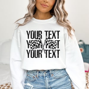 May include: White sweatshirt with black text that says "YOUR TEXT" and a checkered flag graphic.