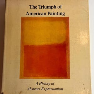 May include: Book cover with the title "The Triumph of American Painting: A History of Abstract Expressionism". The cover features a painting with a yellow top half and a red bottom half.