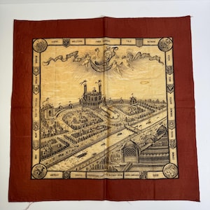 May include: A vintage square scarf with a detailed black and white illustration of a city and surrounding areas, framed by a dark red border. The illustration includes text in French and English, and the scarf is likely made of a lightweight fabric.