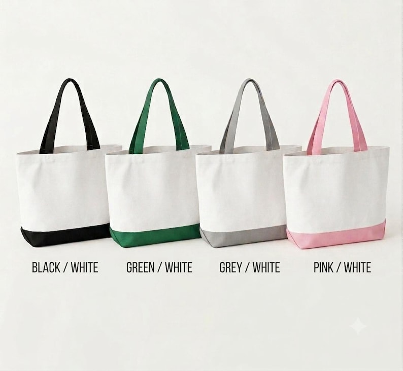 May include: Four tote bags arranged in a row, each featuring a white upper section and a colored base with matching handles. The colors from left to right are black, green, grey, and pink. Text labels below each bag read BLACK / WHITE, GREEN / WHITE, GREY / WHITE, and PINK / WHITE.