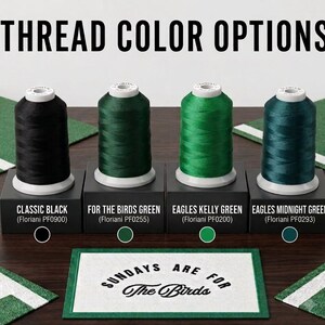 May include: Four spools of embroidery thread in black, dark green, bright green, and teal, labeled Classic Black, For The Birds Green, Eagles Kelly Green, and Eagles Midnight Green. Below, a white rectangular mat reads Sundays Are For The Birds.