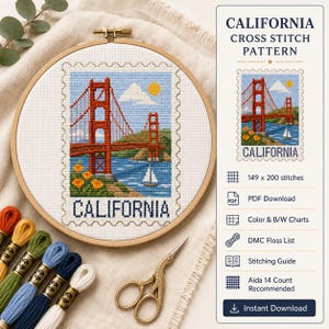 May include: A wooden embroidery hoop containing a cross stitch pattern of the Golden Gate Bridge in California, featuring a red bridge, blue water, yellow flowers, and a sailboat. The text CALIFORNIA is stitched below. Includes embroidery floss and scissors.