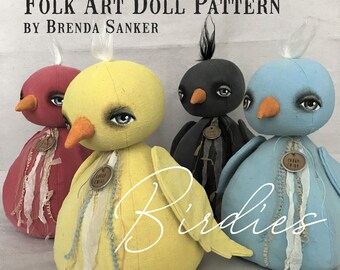 May include: Folk art doll pattern by Brenda Sanker, featuring three handmade bird dolls. The dolls are made of fabric and have painted faces. The birds are a red, yellow, and blue. The dolls are wearing fabric scraps and have a vintage look.