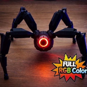 May include: A black, mechanical spider-like robot with articulated legs and a central body featuring a glowing red ring. The image includes the text "FULL RGB Color" in a starburst graphic.