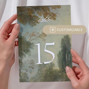 May include: A table number card with a vintage landscape painting background. The number 15 is printed in white on the card. The card is customizable.