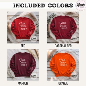 Peut inclure: Image pr&eacute;sentant quatre sweat-shirts de couleur rouge, rouge cardinal, bordeaux et orange. Chaque sweat-shirt affiche le texte "+ Your Design Here +" sur le devant et "Your Design Here" sur la manche. Le texte "INCLUDED COLORS" est &eacute;galement pr&eacute;sent.