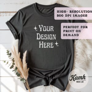 May include: Dark gray t-shirt with rolled-up sleeves. The shirt features the text "YOUR DESIGN HERE" in a stylized font. Additional text on the image reads "HIGH-RESOLUTION 300 DPI IMAGES" and "PERFECT FOR PRINT ON DEMAND".