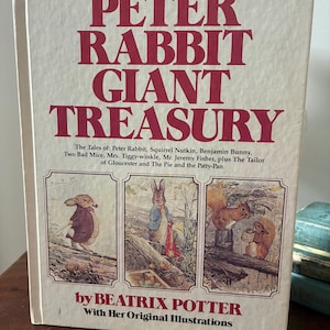 May include: A vintage hardcover book, "Peter Rabbit Giant Treasury", with red text on the cover. The book features illustrations of Peter Rabbit and other characters from Beatrix Potter's stories. Includes original illustrations.
