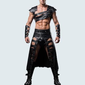 Könnte beinhalten: Schwarzes Leder-Outfit mit einem Top im Harness-Stil mit Riemen und einem Rock mit Ausschnittdetails. Das Outfit umfasst passende Armstulpen und kniehohe Stiefel, alles in Schwarz. Das Design ist kantig und kühn.