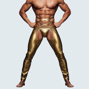 May include: Gold metallic chaps with a crisscross waist design. The chaps have a unique open-leg design and are made of a shiny, reflective material. The garment is a bold fashion statement.